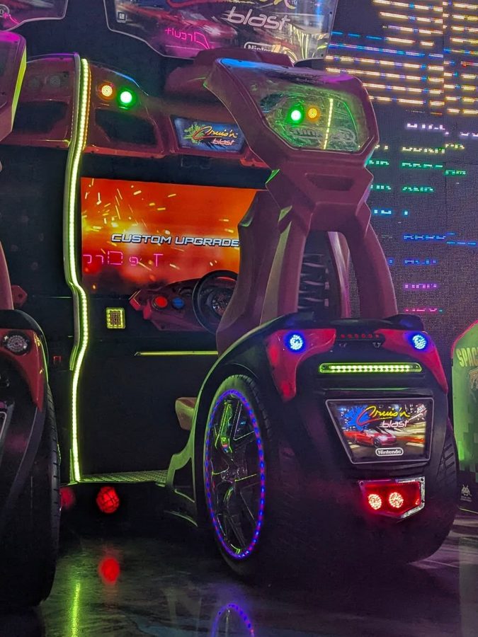 Cruis'n Blast driving cabinet lit up in neon